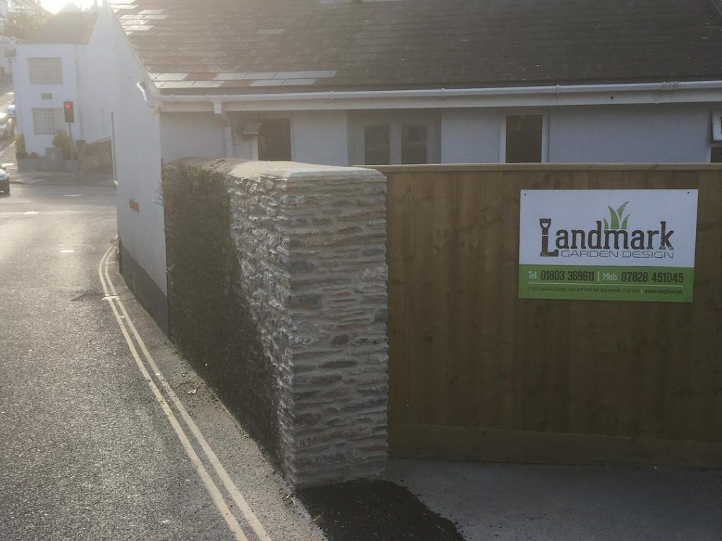 Natural Stone Wall Surrounding Driveway